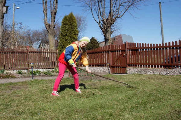 Little girl working in the flower garden — Stock Photo, Image