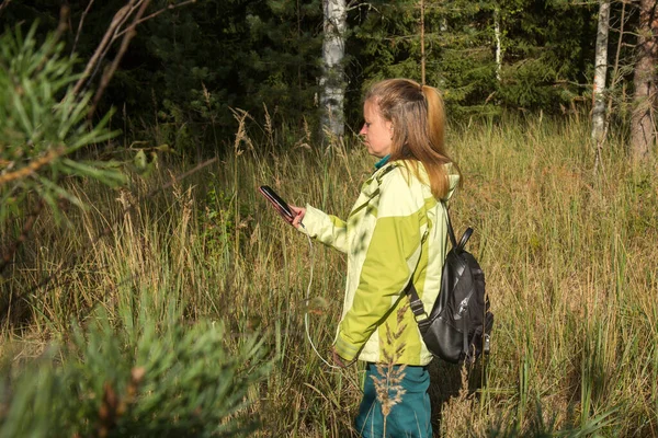 Eine Frau Blickt Wald Auf Ihr Handy Geocaching Spielen — Stockfoto