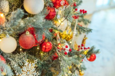 Klasik Noel yılbaşı ağacı kırmızı ve beyaz süsleme oyuncakları ve top ile süslenmiş. Modern klasik stil iç tasarım dairesi. Evde Noel arifesi
