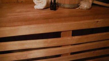 Geleneksel eski Rus hamamı SPA konsepti. Finlandiya sauna saunasında geleneksel sauna aksesuarları ve havlunun aromalı yağ kepçesi kullanılmış. Rahatlayın köy banyosu konsepti.