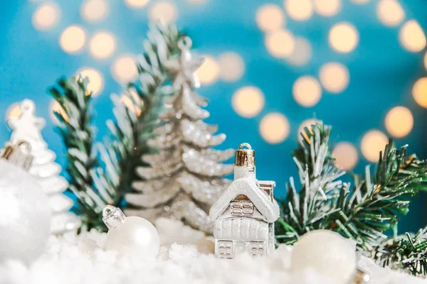 성탄절에는 성탄절을 배경으로 한다. 장난감 집 과 겨울 장식품들은 푸른 배경에 눈으로 덮여 있다. 가정에서 크리스마스를 보내는 모습. — 스톡 사진
