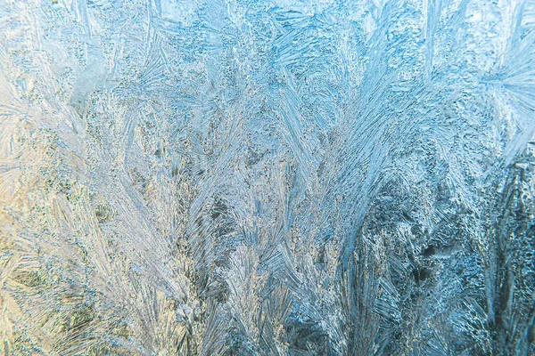 Frozen winter window with shiny ice frost pattern texture. Christmas wonder symbol, abstract background. Extreme north low temperature, natural Ice snow on frosty glass, cool winter weather outdoor. Stock Image