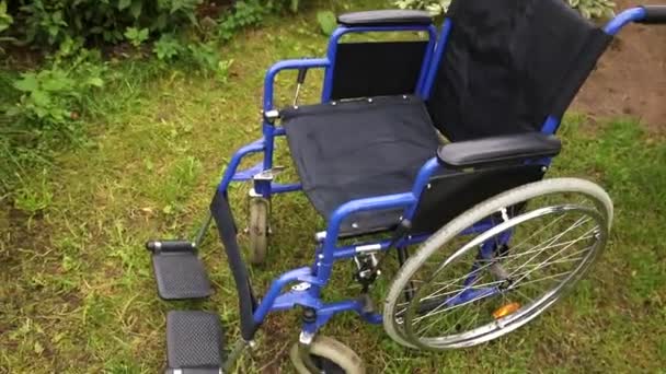 Fauteuil roulant vide debout dans le parc de l'hôpital en attente des services aux patients. Fauteuil roulant pour personne handicapée stationné à l'extérieur. Accessible aux personnes handicapées. Soins de santé concept médical. — Video