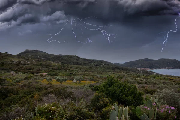 thunderstorm with rain and flashes in the mountains by the sea