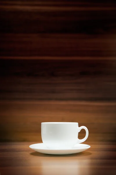 Cup of coffee on dark wood background — Stock Photo, Image