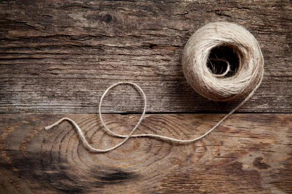 Rope coil on old wooden background — Stock Photo, Image