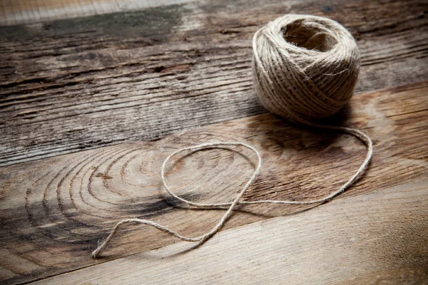 Rope coil on old wooden background — Stock Photo, Image