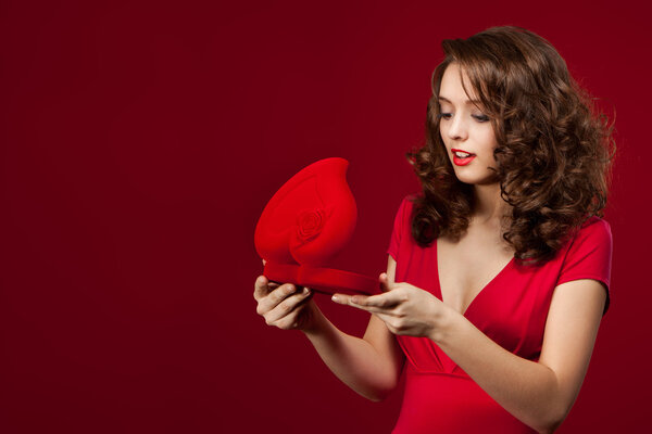 Happy woman opening a gift on Valentine's Day