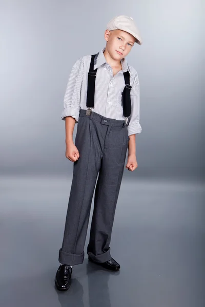 Old fashioned boy and looking sideways on gray background — Stock Photo, Image