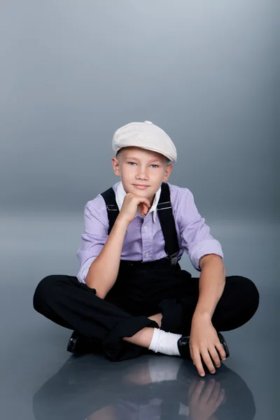 Old fashioned boy sitting and looking to the camera — Stock Photo, Image