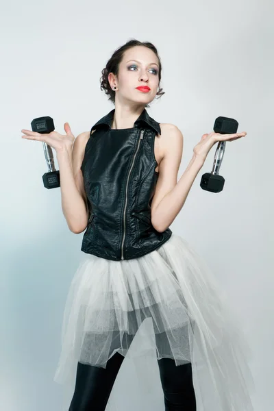 Beautiful fashion model posing with two dumbbells — Stock Photo, Image