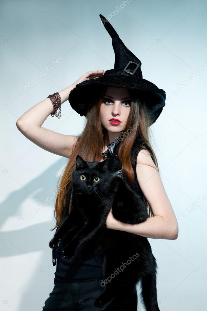 Beautiful witch with black cat
