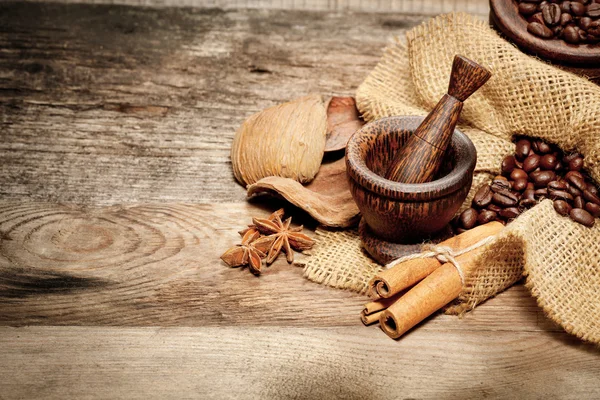 Cinnamon, star anise and coffee beans on old wooden table — Stock Photo, Image