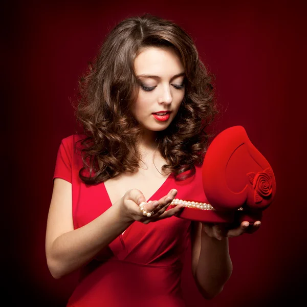 Happy girl opening a gift on Valentine's Day — Stock Photo, Image