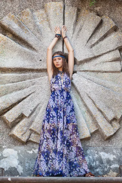 Woman in a sundress at the stone wall — Stock Photo, Image