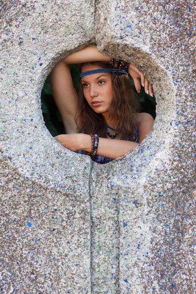 Woman in a sundress at the stone wall — Stock Photo, Image