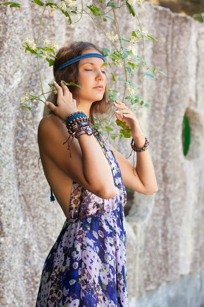 Woman in a sundress at the stone wall — Stock Photo, Image