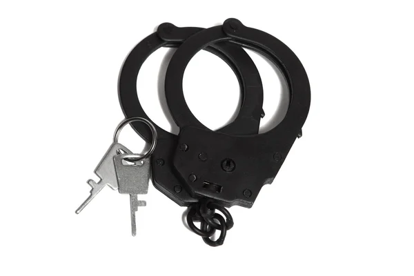 Closed black metal handcuffs and key — Stock Photo, Image