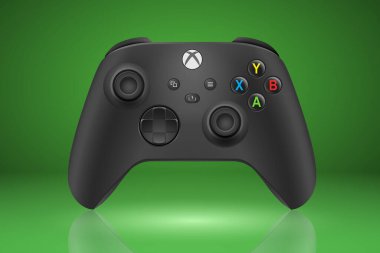 MOSCOW, RUSSIA - DECEMBER 20, 2021: Xbox Series X and Series S gamepad on green background. EPS10 vector illustration with simple gradients. clipart