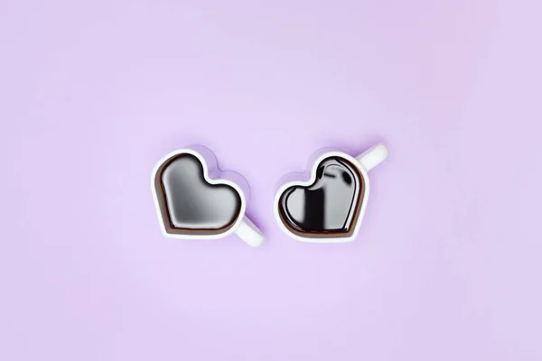 Heart shape coffee cups over purple background. View from above. — Stock Photo, Image
