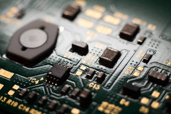Macro photo of a green computer printed circuit board with selective focus on electronic components — Stock Photo, Image
