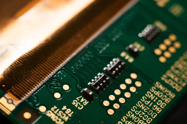 Macro photo of a green computer printed circuit board with selective focus on electronic components — Stock Photo, Image