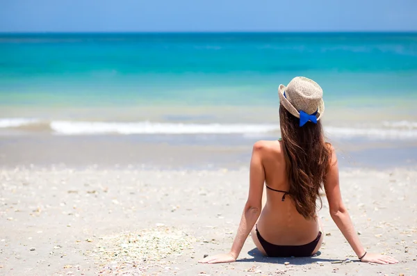 Long haired girl in bikini and straw hat on tropical bali beach Royalty Free Stock Photos