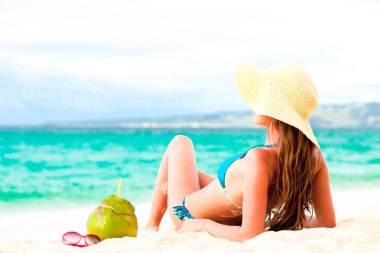Young woman in bikini and straw hat with fresh coconut clipart