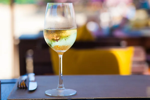 Glas gekoeld witte wijn op tafel in de buurt van het strand — Stockfoto