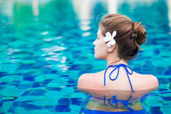 young beautiful woman relaxing in spa pool