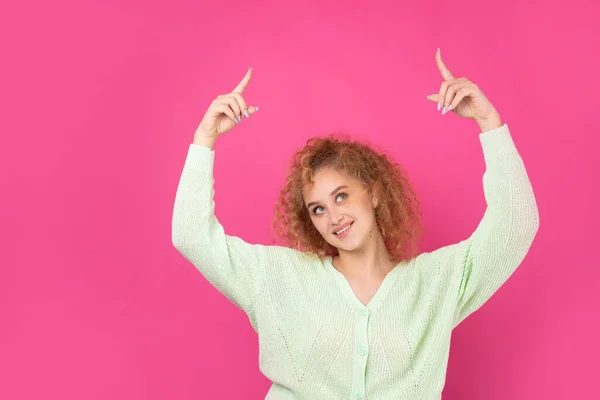 Uma Jovem Com Cabelo Encaracolado Aponta Com Gesto Fundo Estúdio — Fotografia de Stock