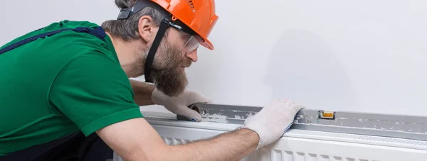 Male Plumber Installs Radiator Heating System Apartment Guy Overalls Gas — Stock Photo, Image