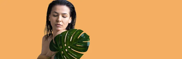 Beauty Woman with natural green palm leaf portrait. Fashion, beauty, make-up, cosmetics.