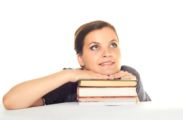 Attractive girl put her hands on the book and looking up while s — Stock Photo, Image