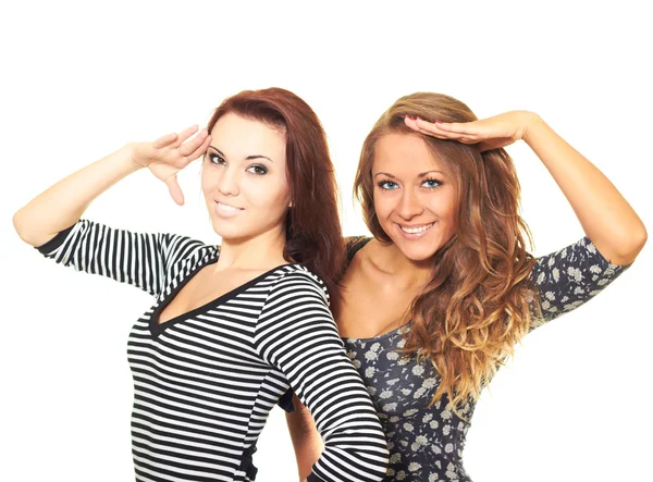 Two attractive smiling girls in dresses salute. — Stock Photo, Image