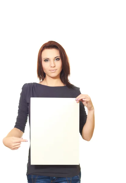 Attractive girl in a gray dress holding a poster and points a fi — Stock Photo, Image