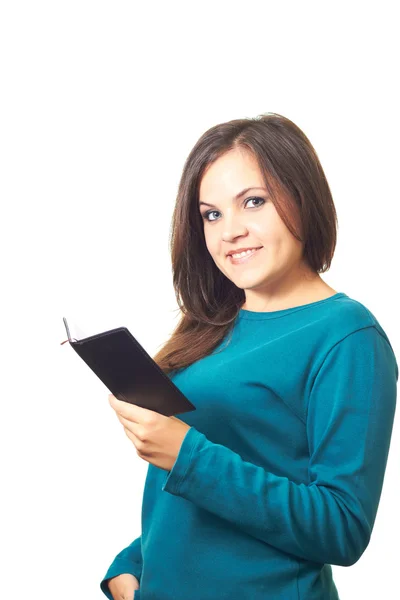 Aantrekkelijke lachende meisje in een blauw shirt houden een notebook in hij — Stockfoto