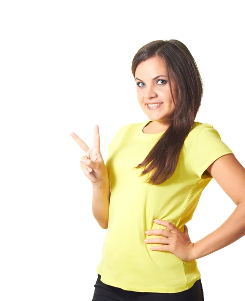 Attractive smiling girl in yellow shirt shows right hand a symbo — Stock Photo, Image