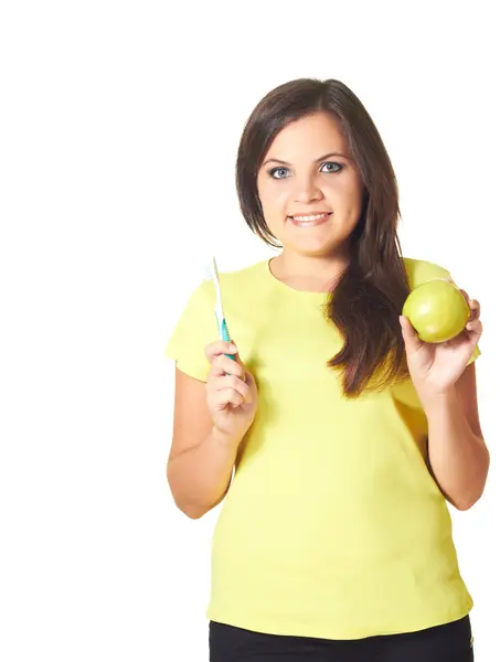 Attractive smiling girl in a yellow shirt holding in her right h — Stock Photo, Image