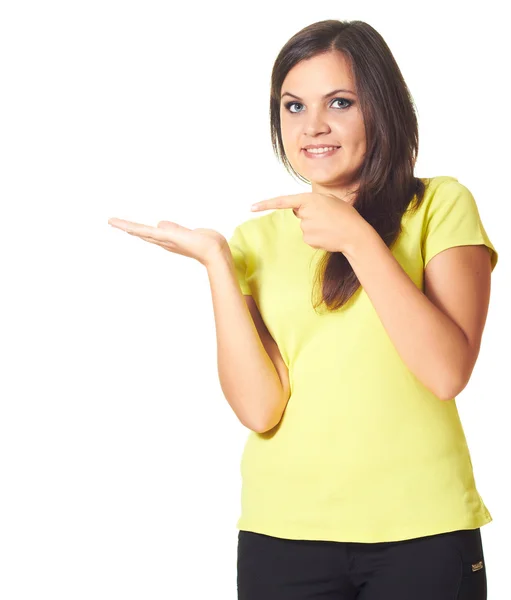 Attractive smiling girl in a yellow shirt holding in her right h — Stock Photo, Image