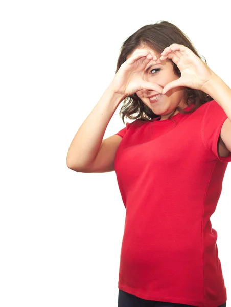 Attractive smiling girl in a red shirt makes the sign of the hea — Stock Photo, Image