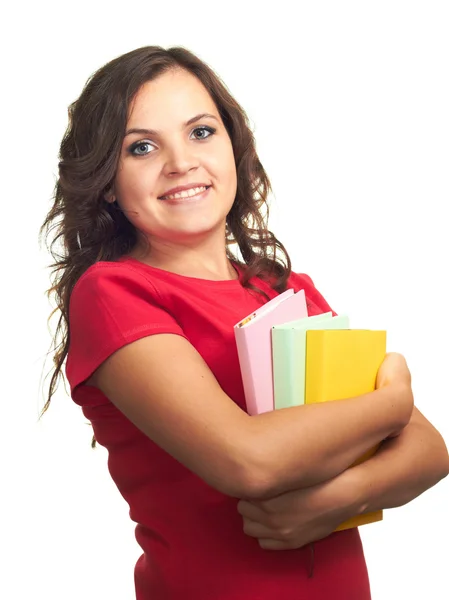 Aantrekkelijke lachende meisje in rood shirt houden een kleurrijke boek. — Stockfoto