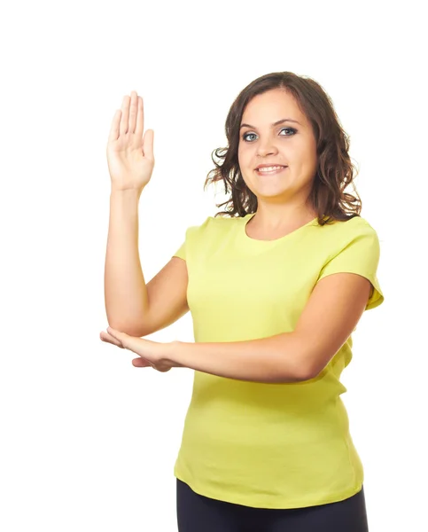 Attractive smiling girl in a yellow shirt raised one arm up. — Stock Photo, Image