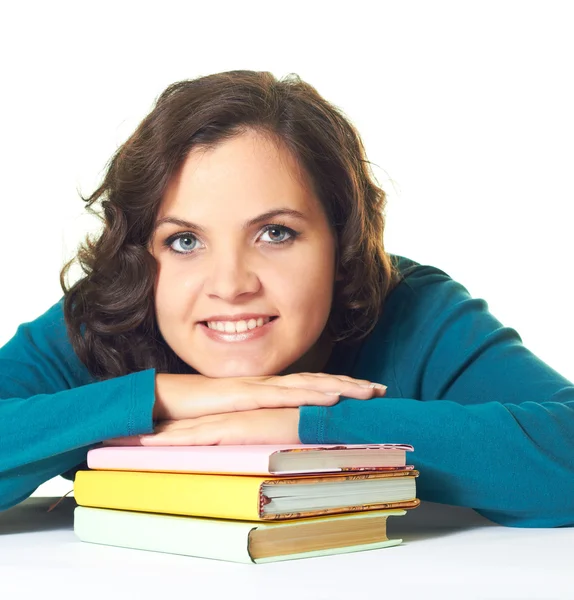 Attractive smiling girl in a blue shirt put her hands on colorfu — Stock Photo, Image