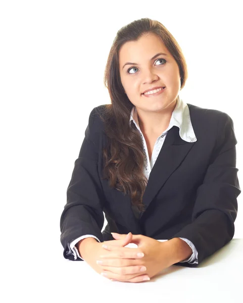 Menina sorridente atraente em um blazer preto, sentado à mesa — Fotografia de Stock