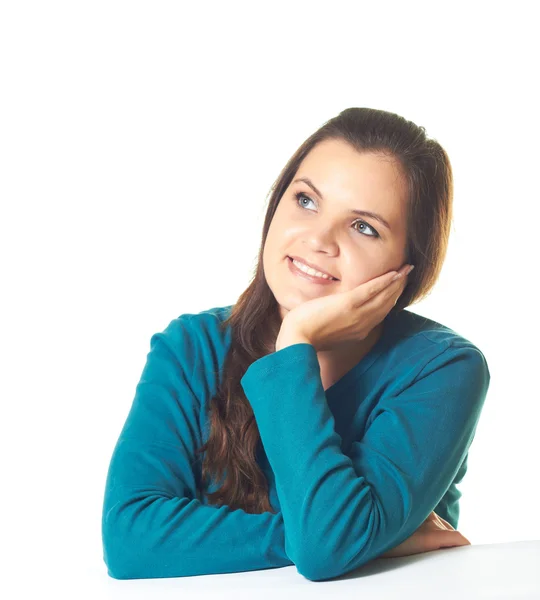 Attractive young smiling girl in a blue shirt sitting at the tab — Stock Photo, Image