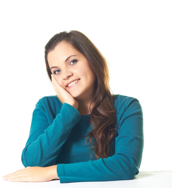 Attractive young smiling girl in a blue shirt sitting at the tab — Stock Photo, Image