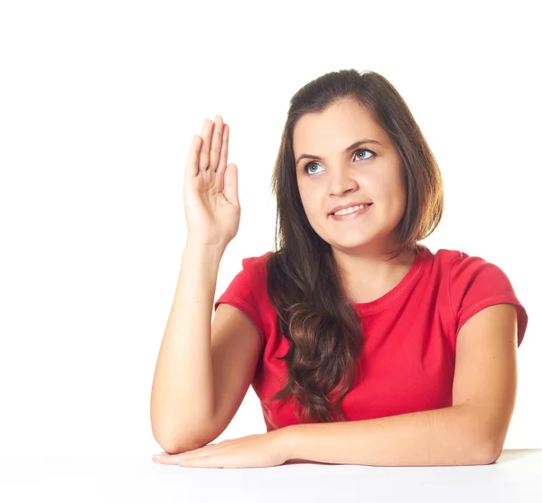 Attraktive junge lächelnde Mädchen in einem roten Hemd am Tisch sitzend — Stockfoto