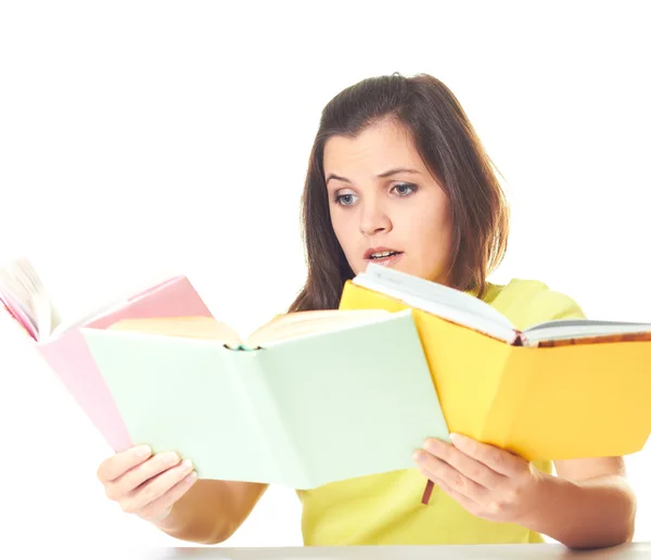 Attractive young girl in yellow shirt sitting at the table and h — Stock Photo, Image