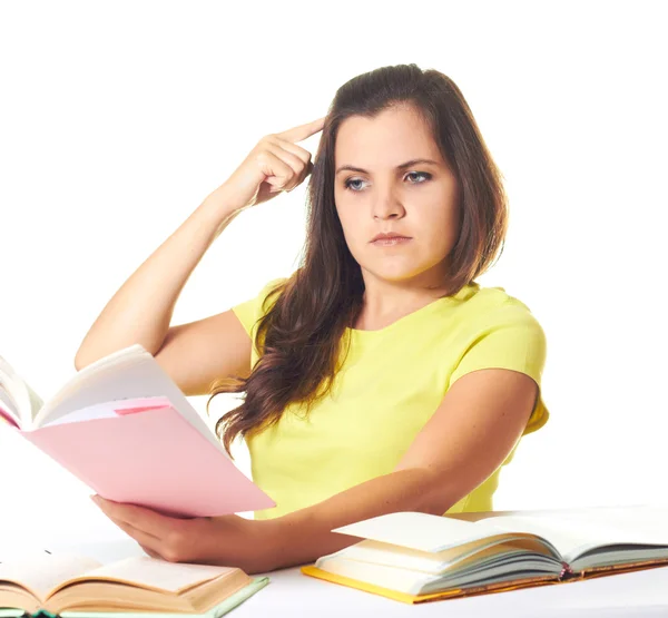 Attractive smiling girl in yellow shirt sitting at the table and — Stock Photo, Image